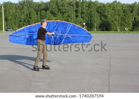 Man training in roller skating with a kite, Novosibirsk, Russia