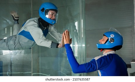 A Man Trains A Woman As An Astronaut. Classes On Flying In A Wind Tunnel.