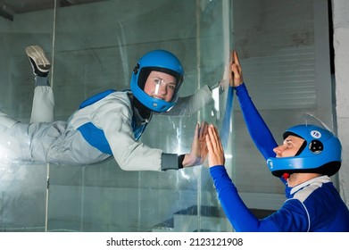 A Man Trains A Woman As An Astronaut. Classes On Flying In A Wind Tunnel.