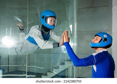 A Man Trains A Woman As An Astronaut. Classes On Flying In A Wind Tunnel.