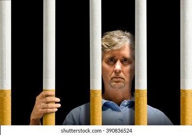 A Man Is Trapped Behind A Prison Of Cigarettes Representing Nicotine Addiction, Depression And The Struggle To Quit Smoking.
