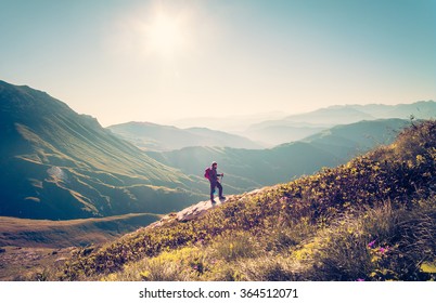 Man Traveler with backpack hiking Travel Lifestyle concept beautiful mountains landscape on background Summer vacations activity outdoor