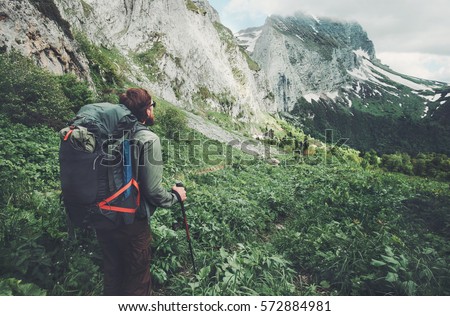 Man traveler with backpack hiking Travel Lifestyle concept adventure active  summer vacations outdoor rocky mountains on background