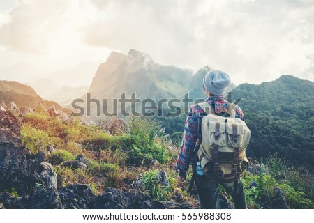 Man Traveler with backpack mountaineering Travel Lifestyle concept