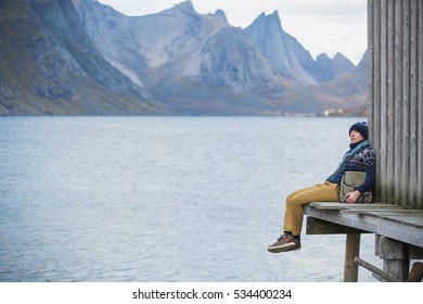 A man traveler with a backpack on a wooden pier. Copy space - Shutterstock ID 534400234