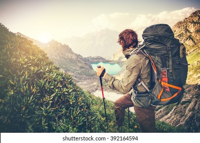 Man Traveler with big backpack mountaineering Travel Lifestyle concept lake and mountains on background Summer extreme vacations outdoor 