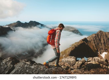 Man Traveler Hiking With Backpack Above Clouds Travel Outdoor In Mountains Adventure Vacation Active Healthy Lifestyle Extreme Sports Summer Activity In Norway