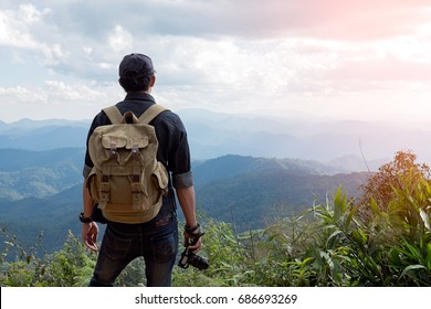 Man Traveler With Photo Camera And Backpack Hiking Outdoor Travel Lifestyle And Adventure Concept.
