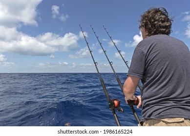 Man With Tree Fishing Rods On The Boat. Deep Sea Fishing In Florida, USA