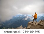 Man trekker on the top of Tofana di Mezzo, enjoying picturesque Dolomite Alps view in Italy. Active people and mountain concept.