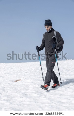 man trekking  on the top of the snowy mountanin