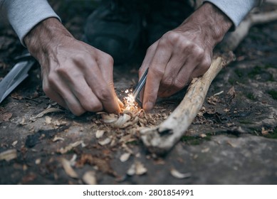 A man tries to make a fire with an angle