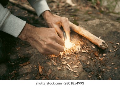 A man tries to make a fire with an angle