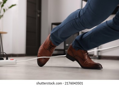 Man Tripping Over Cord In Office, Closeup