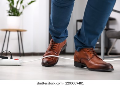 Man Tripping Over Cord In Office, Closeup