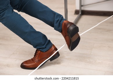 Man Tripping Over Cord In Office, Closeup