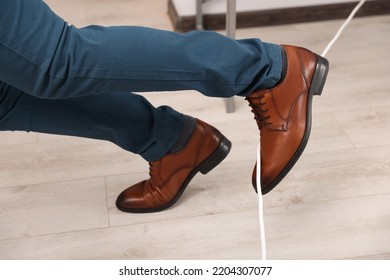 Man Tripping Over Cord In Office, Closeup