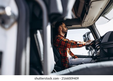 Man Trucker Driving In A Cabin Of His Truck