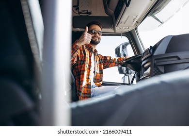 Man Trucker Driving In A Cabin Of His Truck