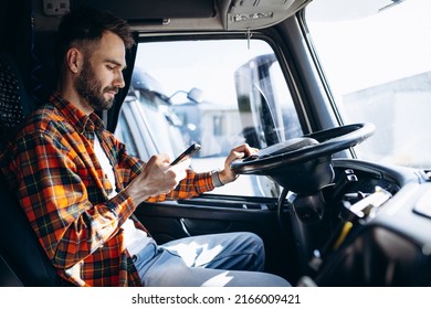 Man Trucker Driving In A Cabin Of His Truck