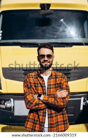Man trucker happy standing by his truck