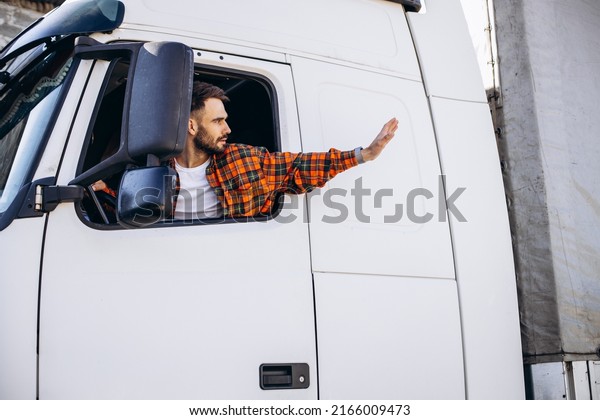 Man trucker sitting in a cabin and looking through\
the window