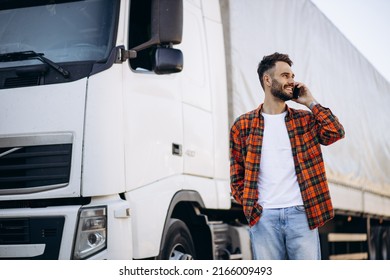 Man Trucker Talking On The Phone By His White Truck