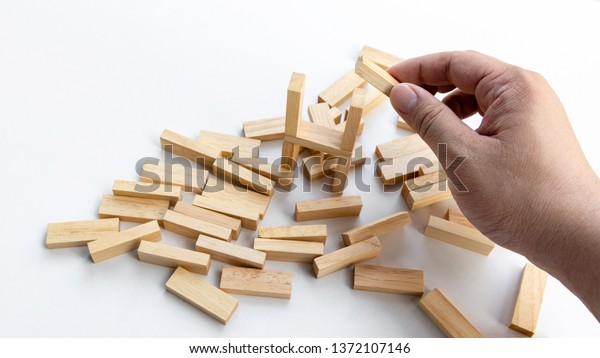 A Man try to rebuild assembly wooden block again\
after broken