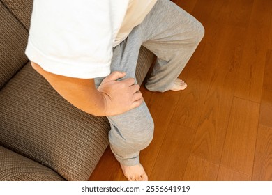 Man trying to get up from the sofa