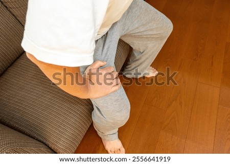 Man trying to get up from the sofa