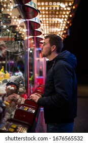 Man trying his luck at the carnivals claw machine