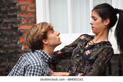 Man trying to kiss woman 