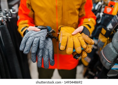 Man Trying On Gloves For Ski Or Snowboarding