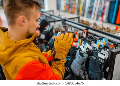 Man Trying On Gloves For Ski Or Snowboarding