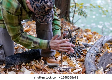 Man Trying To Start A Fire In The Wild Using Primitive Method Of Friction. Practical Survival Skills - Image