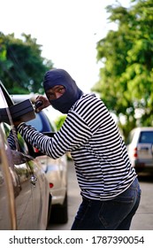 A Man Is Trying To Steal A Car