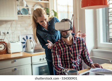 Man trying VR headset at home in the kitchen. - Powered by Shutterstock