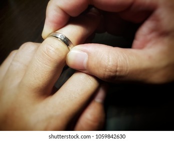 A Man Trying To Wear A Ring. Unfortunately His Finger Is Too Big Or The Ring Is Too Small. Ring Does Not Fit.