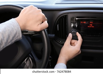 Man Tuning Car Radio, Closeup