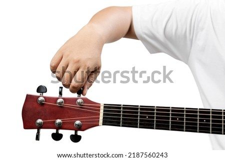 Man tuning guitar string isolated over white background