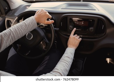 Man Tuning Radio In Car