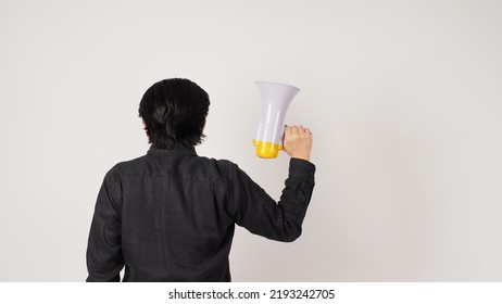 The Man Is Turn Around And Hand Is Holding A Megaphone And Wearing A Black Shirt On White Background. Shrink The Arms