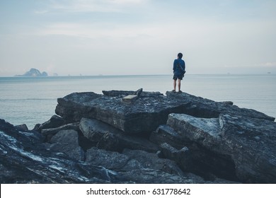 Man turned back to the camera looking at the sea, relaxed, concept of freedom