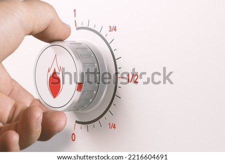 Man turning gas knob to reduce energy consumption. Composite image between a hand photography and a 3D background.