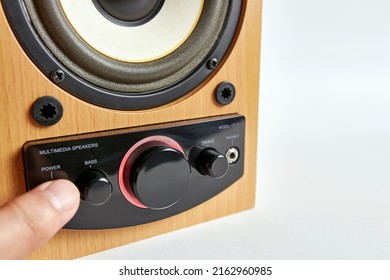 The Man Turns On The Speaker By Pressing The Power Button.