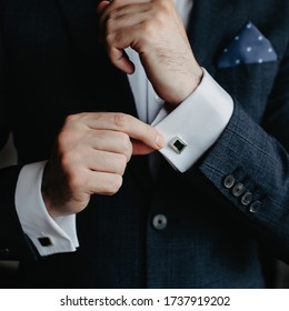 Man In A Tux Fixing His Cufflink.