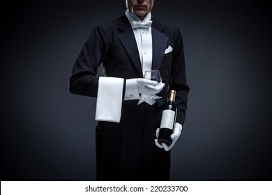 Man in a tuxedo with bottle and glass