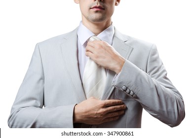 man in a tuxedo tie tightens