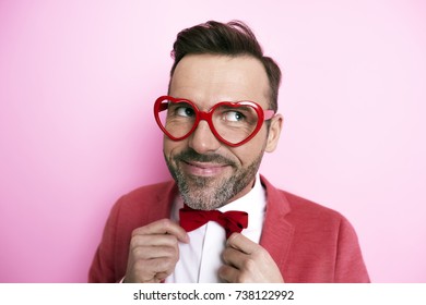 Man in tuxedo tying bow tie   - Powered by Shutterstock