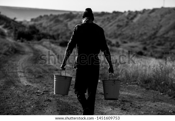 man-two-bucketful-water-village-600w-145